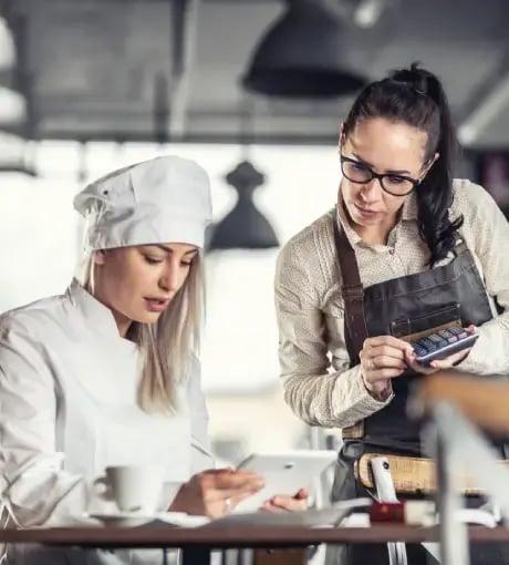 Two chefs calculating costs.